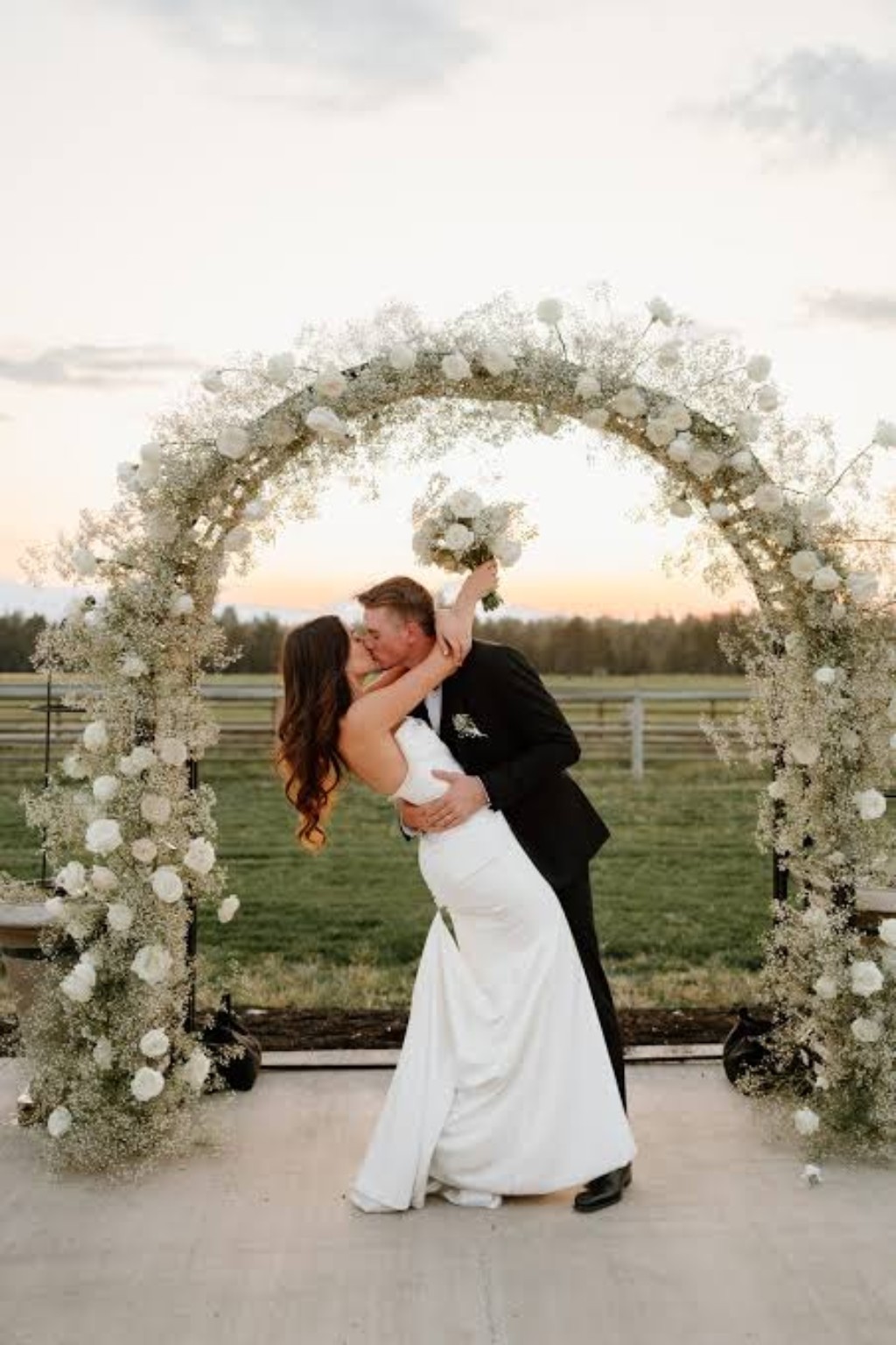 Wedding couple under floral arch